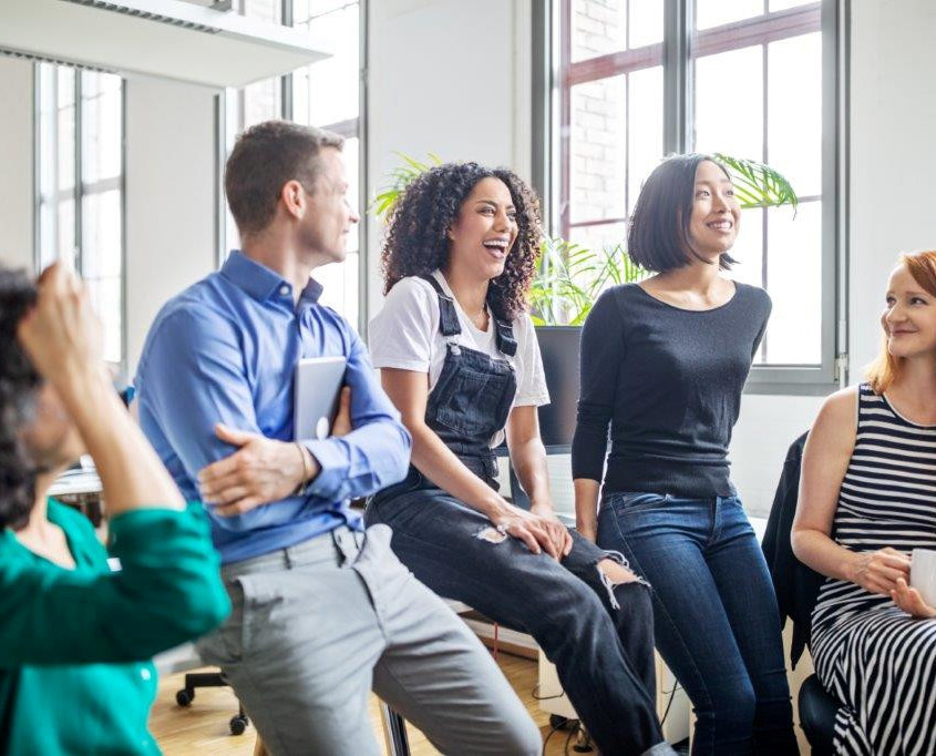 Professionals laughing in a meeting